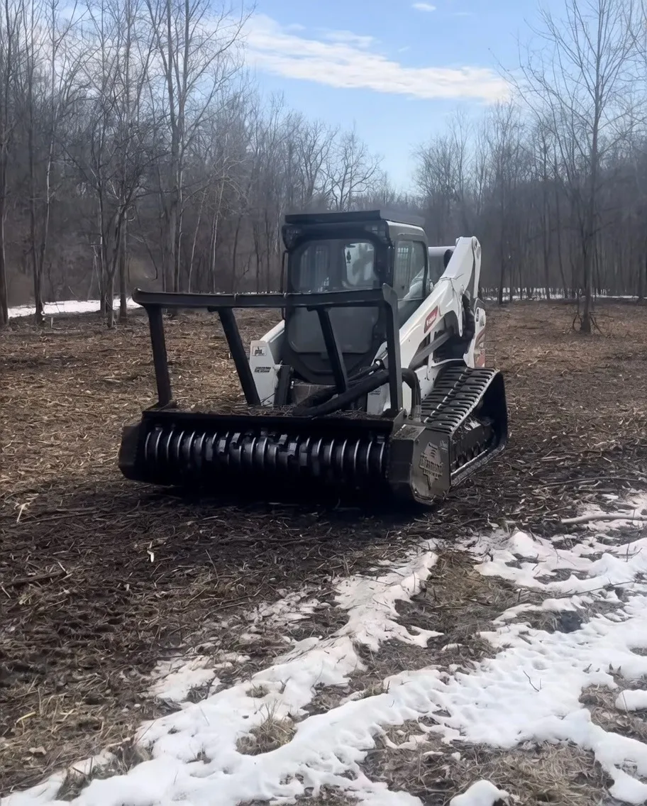 Close-up of forestry mulcher head attachment on track skid steer, Henry County Ohio